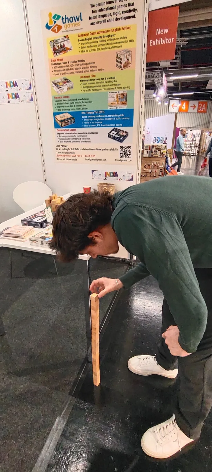 Andre from Spain carefully building a vertical wooden cube structure