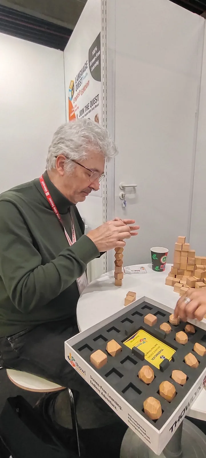 Visitor from Germany concentrating on a wooden balance and construction challenge