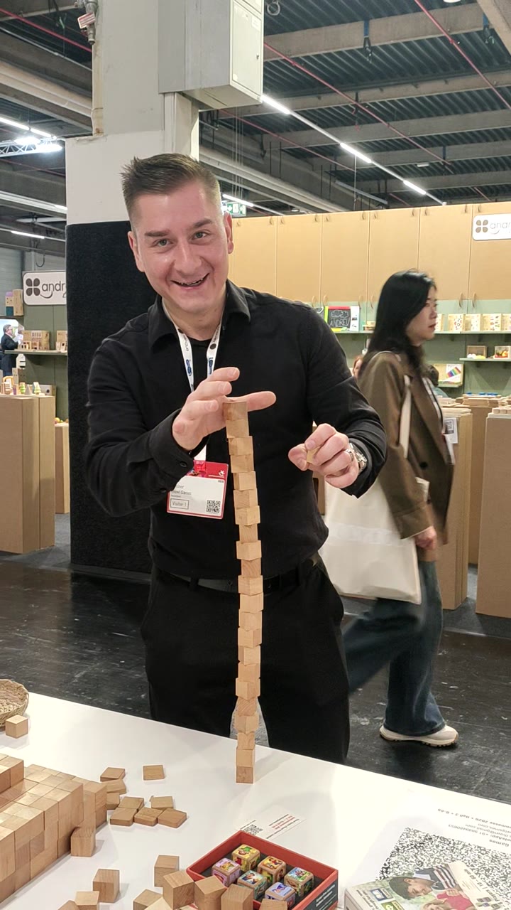 Tim Greiner from Germany building a tall wooden structure at the Thowl Games booth